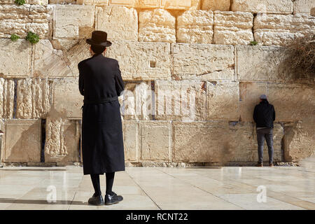 Jerusalem, Israel 13 Januar, 2019 ultra-orthodoxe Juden, Mann, schwarz gekleidet, steht an der westlichen Wand Platz und sieht der westlichen Wand Stockfoto