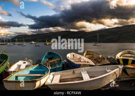 Alte kleine Ruderboote am Loch Broom mit Vintage Fischerboote im Hafen von Ullapool in Schottland Stockfoto