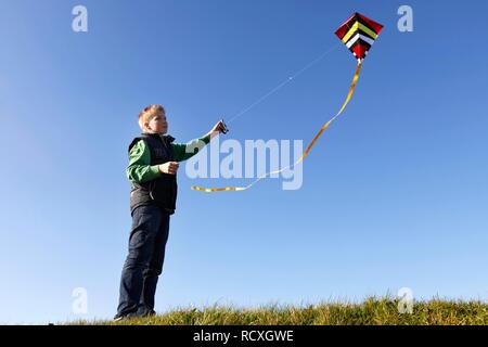 Junge, 12, Flying a Kite Stockfoto