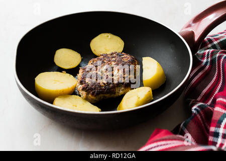 Hausgemachte Frikadelle Lachs mit Kartoffeln in der Pfanne. Organische Meeresfrüchte. Stockfoto