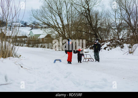 Drei Kinder ziehen Pferdeschlitten im Berg 2019 Stockfoto