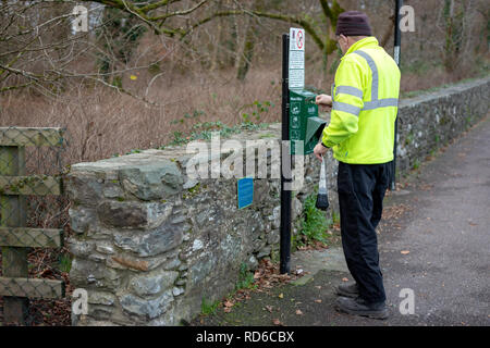 Mitarbeiter des Rates von Mutt Mitt Point für abbaubare Hundemüllbeutel in Killarney, County Kerry, Irland. Spender für mutt Mitt. Stockfoto