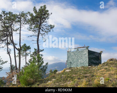 Hunting Lodge auf einem Hügel getarnt. Jäger im Inneren verstecken wartet auf Beute Stockfoto