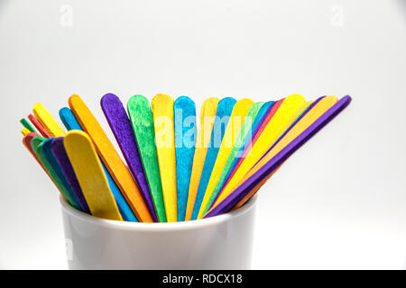 Close up schöne farbige Holz Popsicle stickin Glas weiß auf weißem Hintergrund. Stockfoto