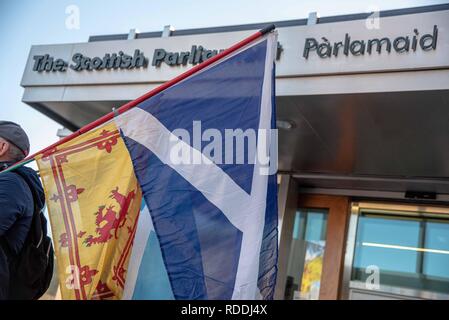 Edinburgh, Lothian, Großbritannien. 17 Jan, 2019. Ein Mann wird gesehen, Flaggen am Eingang des Schottischen Parlaments Gebäude halten. Demonstranten außerhalb des schottischen Parlaments in Edinburgh versammelten Brexit zu protestieren und für eine zweite unabhängigkeitsreferendum zu drücken. Credit: Stewart Kirby/SOPA Images/ZUMA Draht/Alamy leben Nachrichten Stockfoto