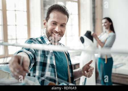 Hilfreich bärtigen Mann helfen, seine Frau als Stylistin arbeiten Stockfoto