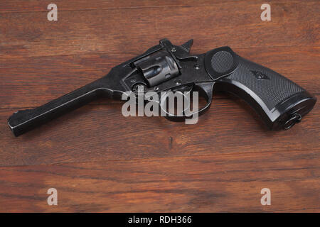 Webley Mk IV Top-Break Revolver, Pistole für die Streitkräfte des Vereinigten Königreichs und das Britische Empire und Commonwealth am Holztisch Stockfoto