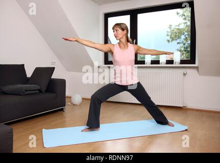 Junge Frau Yoga Übungen zu Hause Stockfoto