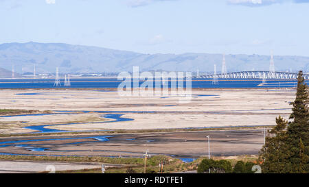 Salz auf den seichten Teichen der San Francisco Bay bei Ebbe, Strom Türme und Dumbarton Bridge im Hintergrund, Kalifornien Stockfoto