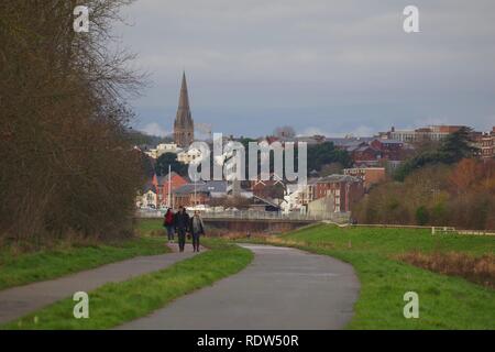 Wanderer durch River Exe Flut Kanal in Richtung Exeter auf der Suche an einem Wintertag. Devon, UK. Stockfoto