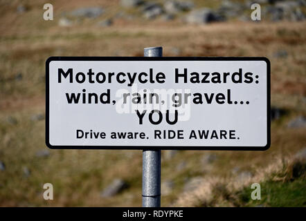 Warnung Schild. Bin Motorrad gefahren: Wind, Regen, Kies ... fahren Sie bewusst. Fahrt bewusst' Kirkstone Pass, Cumbria, England, Vereinigtes Königreich, Europa. Stockfoto