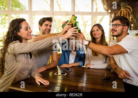 Gruppe von Freunden rumhängen und einen Toast mit Bier Stockfoto