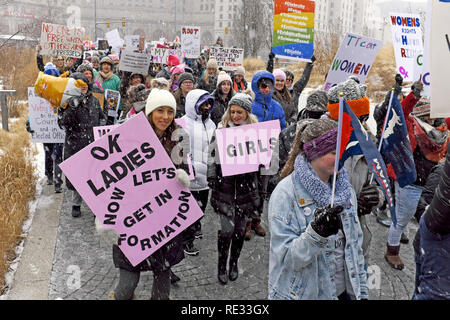 Cleveland, Ohio, USA, 19 Jan, 2019. Die Teilnehmer der 2019 Frauen März und Kundgebung in der Innenstadt von Cleveland, Ohio, USA ihren Weg durch einen öffentlichen Platz mit einem Zeichen, wie sie ihren Marsch durch die Stadt beginnen. Credit: Mark Kanning/Alamy leben Nachrichten Stockfoto