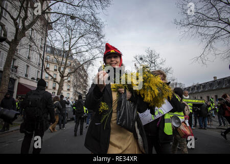 Paris, Frankreich. 19. Jan 2019. Eine Frau trägt den Hut der französischen Symbol 'La Marianne' gesehen wird, die Blumen bei einer Demonstration gegen den französischen Präsidenten Längestrich Politik. Gelbe weste Demonstranten versammelt und marschierten auf den Straßen von Paris ein weiteres Samstag auf, was Sie die Akte X gegen die Politik der französische Präsident Emmanuel's Längestrich nennen. Credit: SOPA Images Limited/Alamy leben Nachrichten Stockfoto