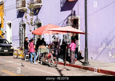 Mexikanische einheimische versammeln sich um ein Street Food vendor am Morgen in Puebla, Mexiko Stockfoto