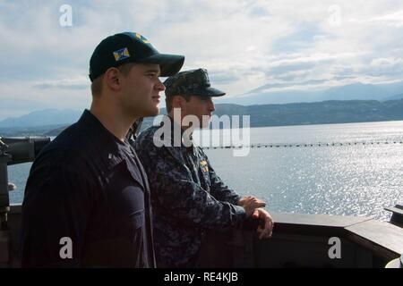 Die SOUDA BUCHT, Griechenland (Nov. 18, 2016) Lt. j.g. James Schnee von Pierre, S.D., Links, und Lt. j.g. Derek Fox von Caribou, Maine, die auf der Insel Kreta Blick vom Hafen Brücke Flügel der geführten Anti-raketen-Zerstörer USS Mason (DDG87) während eines Hafen besuchen. Mason, eingesetzt als Teil der Eisenhower Carrier Strike Group, ist die Durchführung von naval Operations in den USA 6 Flotte Bereich der Maßnahmen zur Unterstützung der US-amerikanischen nationalen Sicherheitsinteressen in Europa. Stockfoto