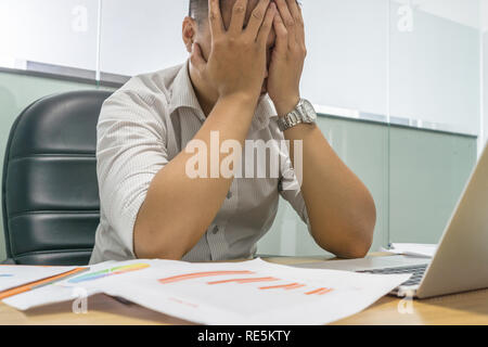 Der Geschäftsmann, der sich besorgt und mit Business gedrückt Stockfoto