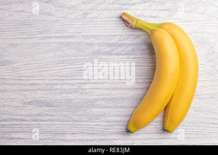 Süße reife zwei Bananen auf einem weißen Holztisch. Schriftfeld Stockfoto
