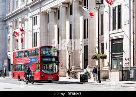 London, UK, 21. Juni 2018: Hohe Kommission von Kanada mit roten Kanadische Fahnen und Double Decker Bus für Waterloo Zeichen auf Cockspur Street in Westminste Stockfoto