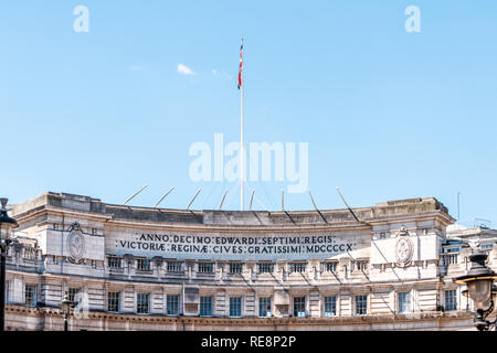 London, UK Buckingham Palace top von außen Tore genannt Admiralty Arch Nahaufnahme von Flagge und lateinischen Wörter in Vereinigtes Königreich Stockfoto