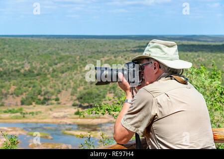 Männliche Fotografen auf Fotoshooting mit Blick auf den Fluss Olifants, Krüger Nationalpark, Südafrika Stockfoto