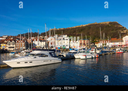 Kleine Boote im Hafen von Scarborough North Yorkshire im Vereinigten Königreich, mit dem Schloss auf dem Hügel hinter Stockfoto