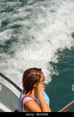 Gardasee, Italien - September 2018: Person an Bord der Fähre am Gardasee Blick von der Rückseite des Bootes. Stockfoto