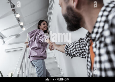 Frau in Jeans und Lila hoodie die Hand der Mann Stockfoto