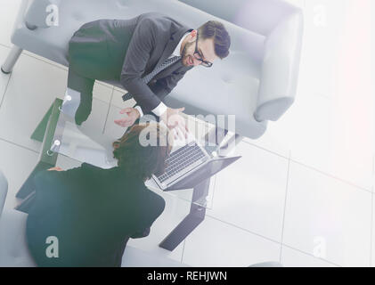 Zwei Geschäftsleute über Aufgaben im Büro sitzen. Stockfoto