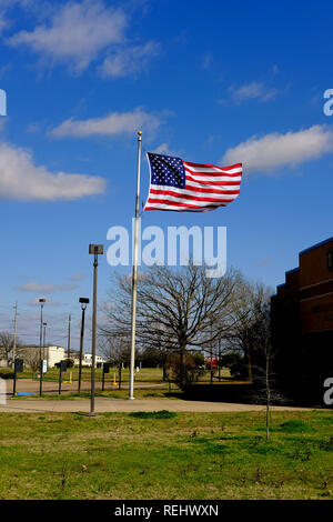 Amerikanische Flagge ausserhalb der Bryan, Texas, USA Post; Fahne im Wind. Stockfoto