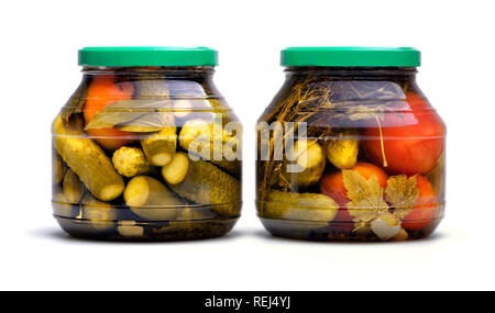 Essen und Trinken: hausgemachte Marmeladen, eingelegte Gurken und Tomaten im Glas, auf weißem Hintergrund Stockfoto