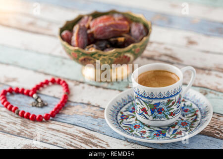 Türkischer Kaffee, Termine und herzförmige Rosenkranz auf Türkis Tabelle Seitenansicht Stockfoto