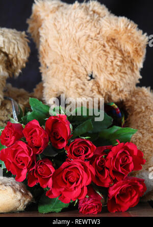 Strauß roter Rosen und paar Teddybären. Niedlichen Teddybären Paar mit Rosen. Happy Valentine's Day card. Romantische Grusskarten für Hochzeit Stockfoto