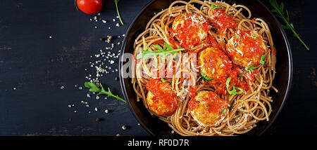 Italienischen Pasta. Spaghetti mit Fleischbällchen und Parmesan in schwarze Platte auf dunklen rustikalen, mit Holz Hintergrund. Abendessen. Ansicht von oben. Slow food Konzept Stockfoto
