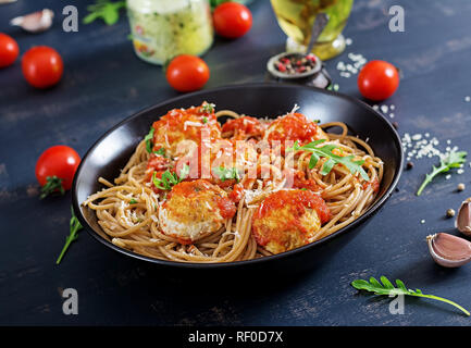 Italienischen Pasta. Spaghetti mit Fleischbällchen und Parmesan in schwarze Platte auf dunklen rustikalen, mit Holz Hintergrund. Abendessen. Slow food Konzept Stockfoto