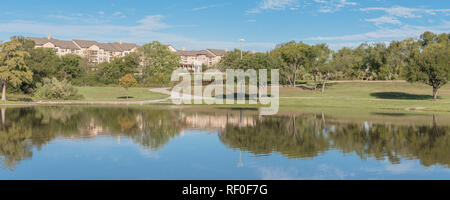 Panoramablick auf die städtischen Park mit See Reflexion und Apartment Komplex im Hintergrund in der Nähe von Dallas Stockfoto