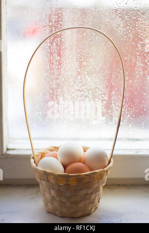 Huhn Eier in einem Weidenkorb. Rohe Eier sind reichlich vorhanden. Vorbereitung auf Ostern. Stockfoto