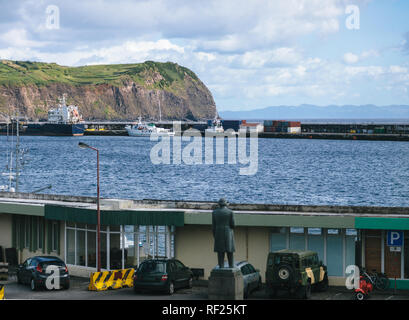 Blick auf die Bucht von Horta und seinen Hafen mit Wolken im Himmel und die Berge im Hintergrund Stockfoto