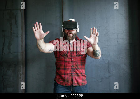 Aufgeregt, bärtigen Mann mit VR-Brille Stockfoto