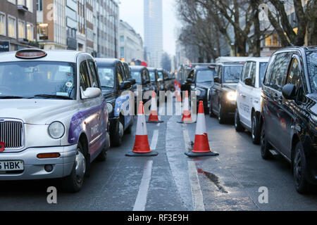 London, Großbritannien. 24 Jan, 2019. Taxifahrer Bühne ein Protest Blockade der Tottenham Court Road aufgrund von Transport for London Autos verbieten, auf der Straße. Credit: Penelope Barritt/Alamy leben Nachrichten Stockfoto