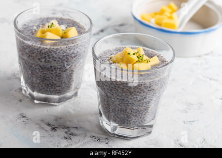 Mango Chia pudding Mandelmilch in Gläsern, gesundes Frühstück essen, leckere Nachspeise oder Zwischenmahlzeit Stockfoto