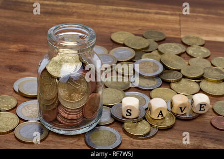 Euro Münzen in einem Geld, um eine Tabelle mit dem Wort zu speichern, auf dem Tisch isoliert Stockfoto