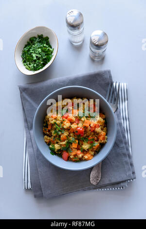 Healhty vegan Schüssel mit Quinoa, Kürbis, Paprika und Karotte auf grau Holz- Hintergrund. Selektiver Fokus Stockfoto