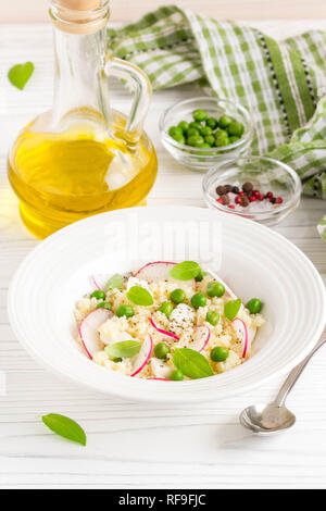 Salat mit Couscous, grüne Erbsen, Mozzarella und Rettich, Sommer gesundes Gericht Stockfoto