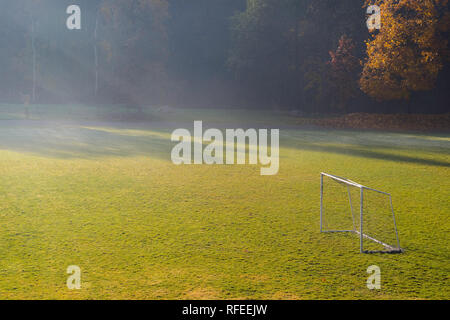 Early morning in the amatuer soccer field. Football game playground in autumn foggy morning. Early morning in the amatuer soccer field. Football game  Stockfoto