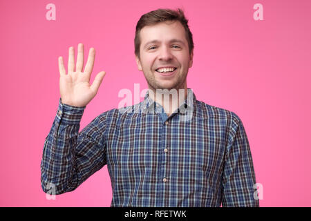 Mann in karierten blaues Hemd Hallo, winken eine Hand. Stockfoto