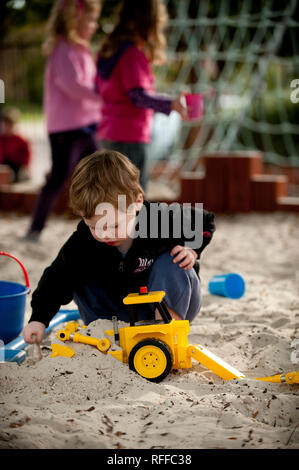 Kleinkind spielen in einer Sandkuhle Stockfoto