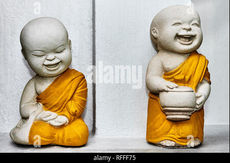 Miniatur Stein geschnitzte buddhistische Mönche vor einem Tempel in Bangkok, Thailand Stockfoto