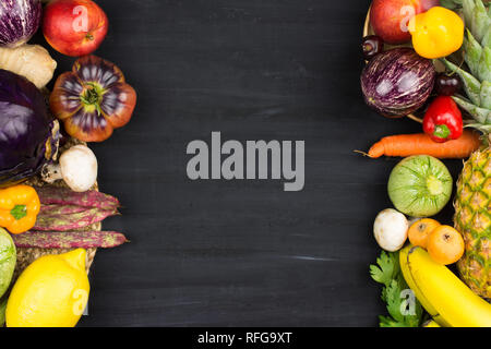 Rahmen von frischen und biologischen Gemüse und Früchte auf schwarzen Hintergrund mit Kopie Raum Stockfoto
