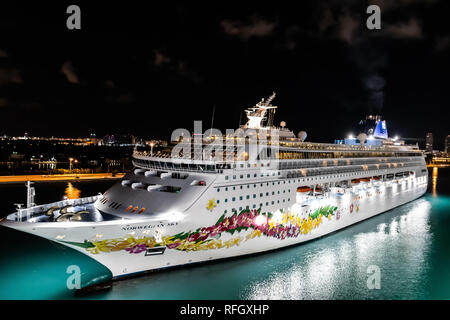 Miami, Florida - 19. November 2018: Norwegian Sky Kreuzfahrten Segeln in den Hafen von Miami, kurz vor Sonnenaufgang mit der Skyline von Downtown Miami Stockfoto